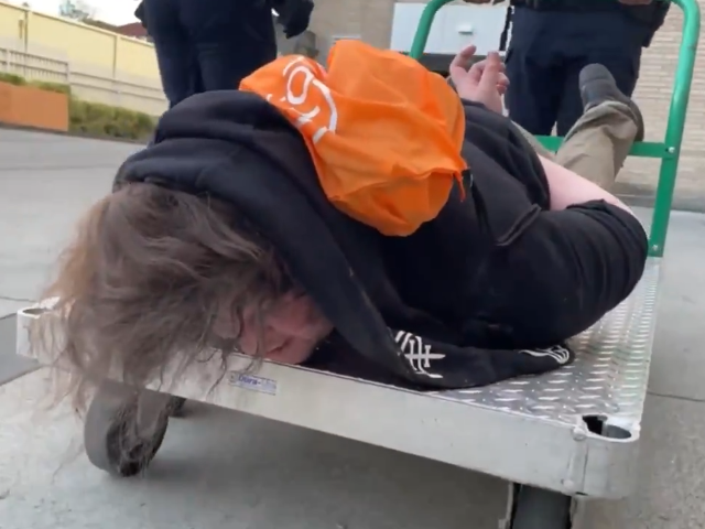 WATCH: ICE Officers Haul Cuffed Portland Suspect on Flatbed Cart Amid Protests
